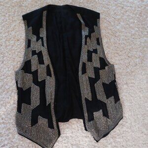 Black vest featuring silver beadwork in a geometric design -